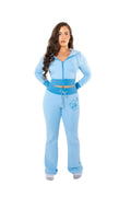 Woman wearing a light blue tracksuit on a white background
