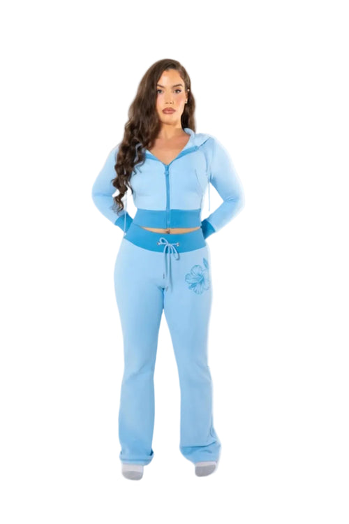 Woman wearing a light blue tracksuit on a white background